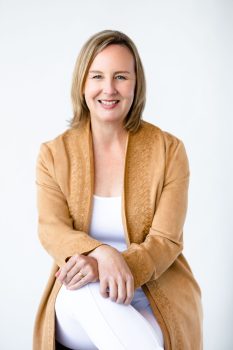 Sandy with knees crossed